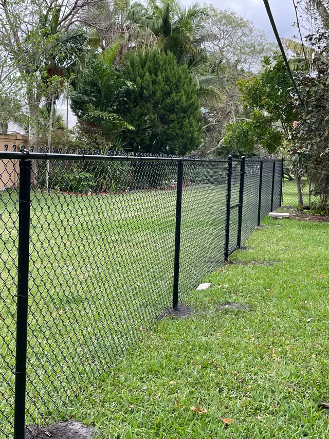 Black chain-link fence installed by Florida Fence Solution in Broward County