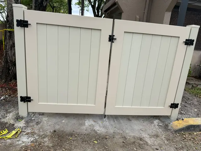 Tan PVC double gate fence installed by Florida Fence Solution in Broward County