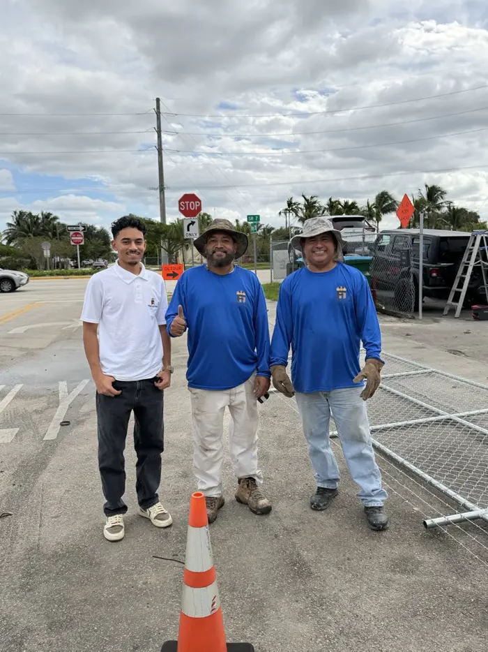 Three members of the Florida Fence Solution crew at a job site